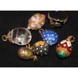 A mid 19th century gold and gem set mourning ring and six assorted egg charms.