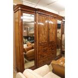 A large Victorian 'plum pudding' mahogany breakfront wardrobe, W.280cm H.241cm