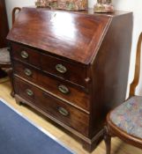 A George III mahogany bureau, with fitted interior, two short and two long drawers, W.107cm