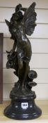 After Moreau. A bronze angel with lilies, height 57cm