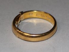 A 22ct gold wedding band with 9ct gold inner sizer, gross 8 grams, size V.