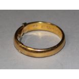 A 22ct gold wedding band with 9ct gold inner sizer, gross 8 grams, size V.