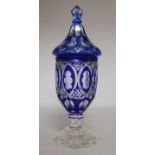 A blue overlaid glass vase and cover
