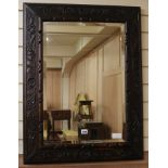 An early 20th century carved oak wall mirror, with bevelled glass plate, W.67cm H.87cm