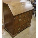 A George III oak bureau, with fitted interior and four long drawers, W.100cm