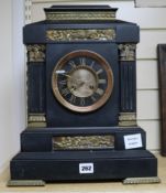 A large 19th century French black marble eight day mantel clock, with gilt brass inset panels,