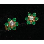 A pair of gold, emerald and diamond cluster ear studs.