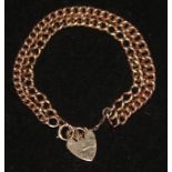 An adapted double strand 9ct gold and 15ct gold curb link bracelet with heart shaped padlock.
