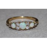 A gold, white opal and diamond dress ring, size L.