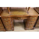 A walnut kneehole desk, with serpentine front, W.115cm