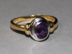 An 18ct and amethyst set ring, size O.