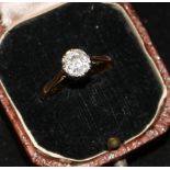 An early 20th century 18ct gold and platinum solitaire diamond ring, size O.