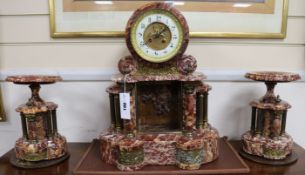 A 19th century French rouge marble three piece clock garniture, height 47cm