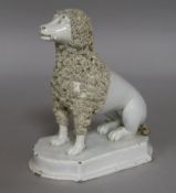An early 19th century pearlware poodle with bone
