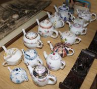A collection of 14 miniature teapots