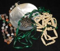 An agate bead necklace, a malachite necklace an ivory necklace a carved shell and pique cross brooch