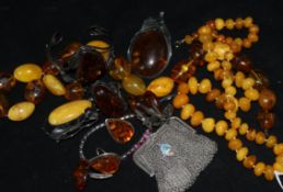 Two amber necklaces, other amber and amberoid jewellery, a silver purse and paste bracelet.