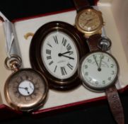 A Cartier travelling clock and three watches.