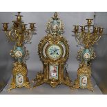 A Louis XV style 3 piece clock set flanked by 5-light candelabra