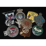 A collection of RAC, MG and other car badges