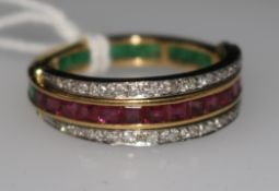 An 18ct gold, ruby, diamond and emerald triple band swivel ring, size R.