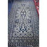 An Indian ivory & blue ground rug , 300cm x 152cm