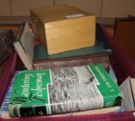 A collection of fishing books and flys