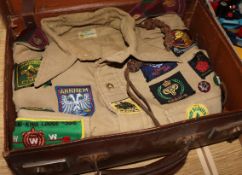 Two Bukta scout shirts with badges, 1950's-60's in a case