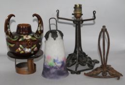 Two Art Nouveau wrought iron lamp bases, an Arts & Crafts copper stand and a Continental pottery