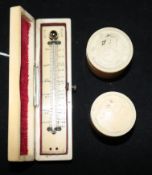 An ivory-cased pocket thermometer and two Meiji Japanese cylindrical boxes and covers.