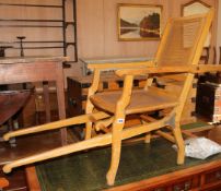 An early 20th century caned beech folding steamer chair, overall L.155cm