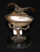 A 19th century Continental bronze and mother of pearl pedestal dish, modelled as an eagle perched