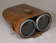 A pair of leather cased binoculars