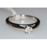 A 14ct white gold and solitaire diamond ring, the round brilliant cut stone weighing 0.28cts, size