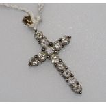 A 9ct gold and diamond set cross pendant, 1in inc. bale.