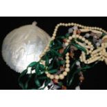 An agate bead necklace, a malachite necklace an ivory necklace a carved shell and pique cross brooch