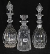 A pair of cut glass decanters and another