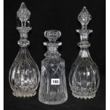 A pair of cut glass decanters and another