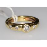 An 18ct gold and five stone diamond ring, size L.