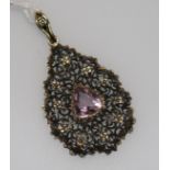 An early 20th century pierced 15ct gold and amethyst pear shaped pendant, 2in.