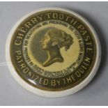 A pot lid "Cherry Toothpaste, Patronized by the Queen", showing a profile portrait of the Queen, the