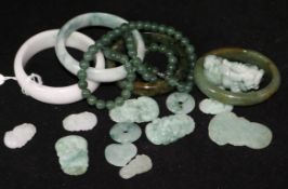 A quantity of jadeite items including bangles, a necklace and carvings.