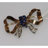 A gold, sapphire and diamond set bow brooch. 34mm.