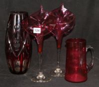 A pair of cranberry 'Jack in the Pulpit' vases, a cranberry jug and an overlaid vase