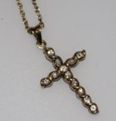 A 9ct gold and diamond set cross pendant on a 9ct gold chain, pendant 1in.
