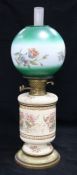 A ceramic based and floral glass shaded oil lamp