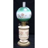 A ceramic based and floral glass shaded oil lamp