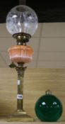 A brass oil lamp and a glass lamp base