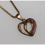 A 9ct gold and ruby set heart pendant on a 9ct gold chain.