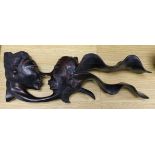 A Chinese hardwood carving of two heads, 34cm